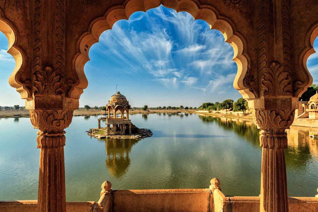 Indian landmark Gadi Sagar - artificial lake view through arch.